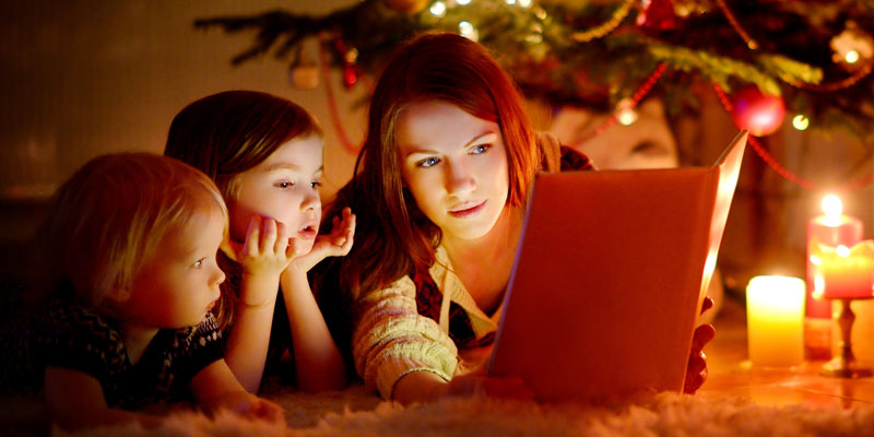 Mom and child in front of laptop.